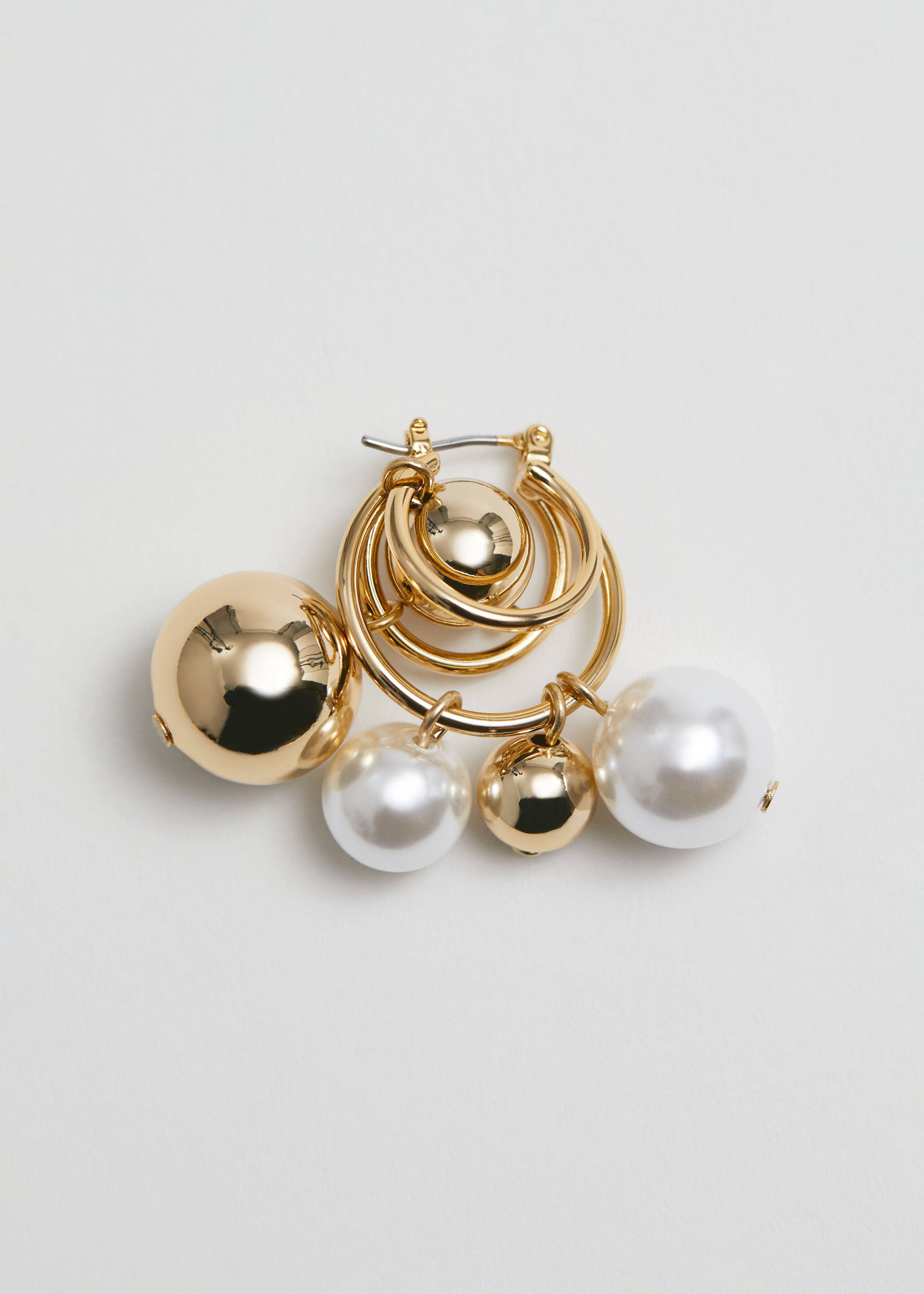 Verzierte Ohrringe - {{variantName}} - Beschreibendes Detail