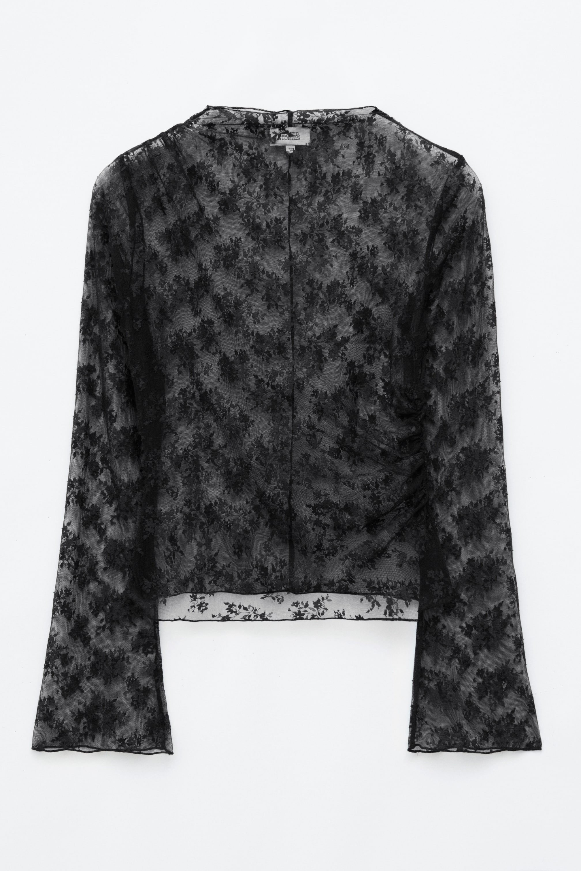 Ver imagen más grande: Un top de encaje negro presentado de frente, que muestra un estampado floral semitransparente, cuello alto redondo y mangas largas acampanadas con remates baby lock. El top presenta fruncido asimétrico en un hombro y en la costura lateral opuesta, creando una silueta drapeada.