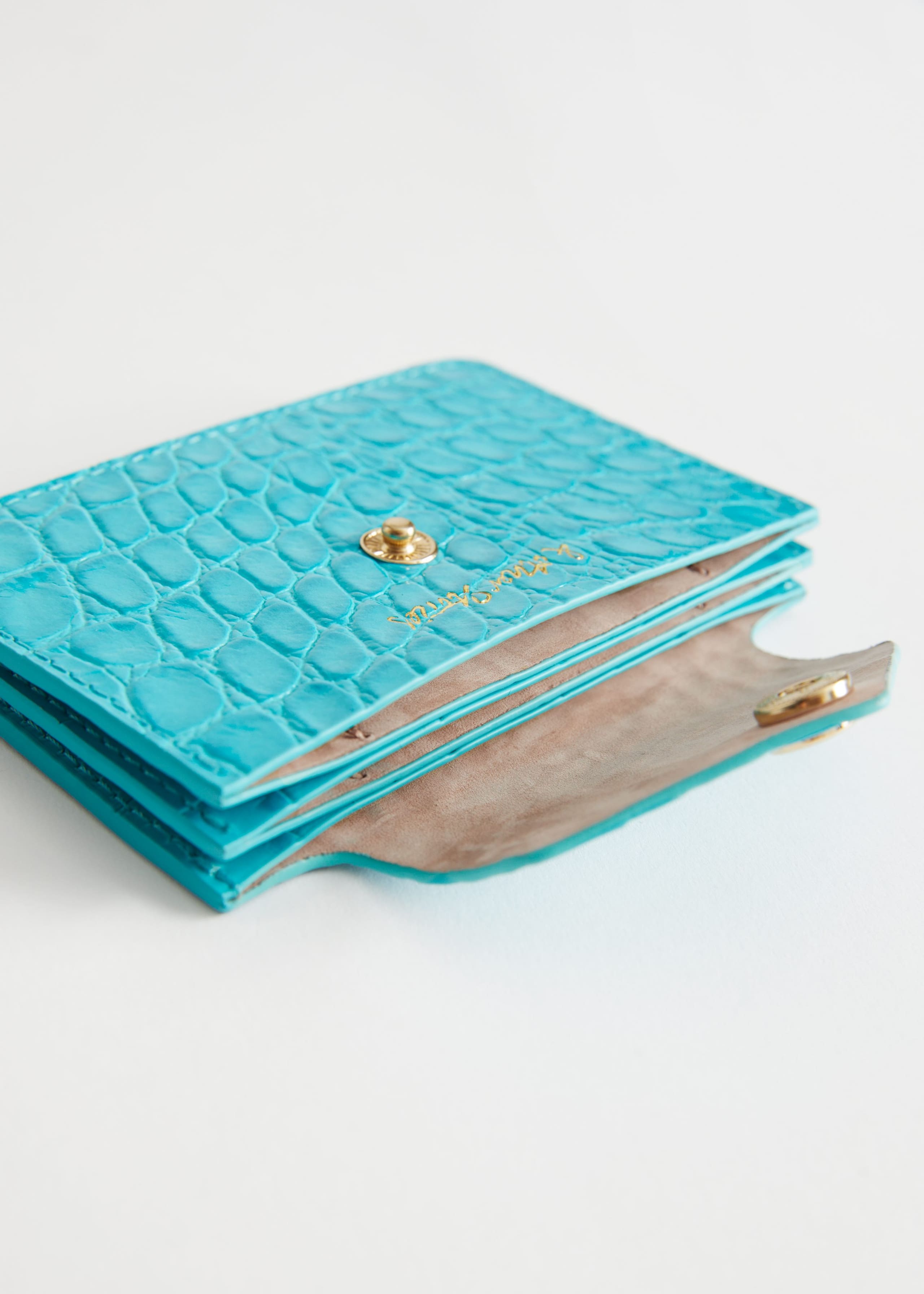 Tarjetero de piel - {{variantName}} - Detalle descriptivo