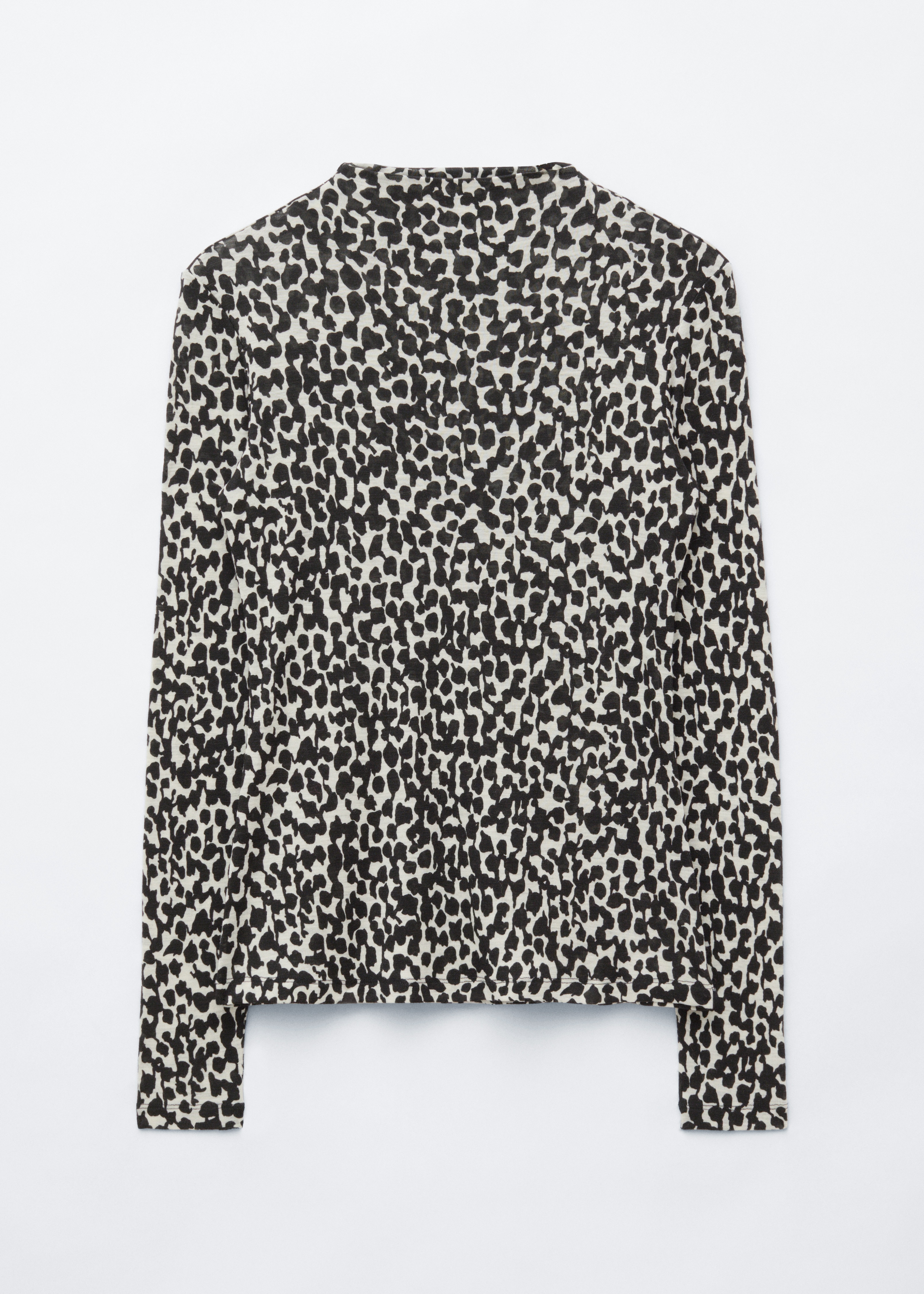 A wool mock-neck top with a black and white abstract animal print is worn by the model, tucked into a black skirt with a belted waist. The long-sleeved, fitted top is styled with a large black leather clutch held in the model's hand.