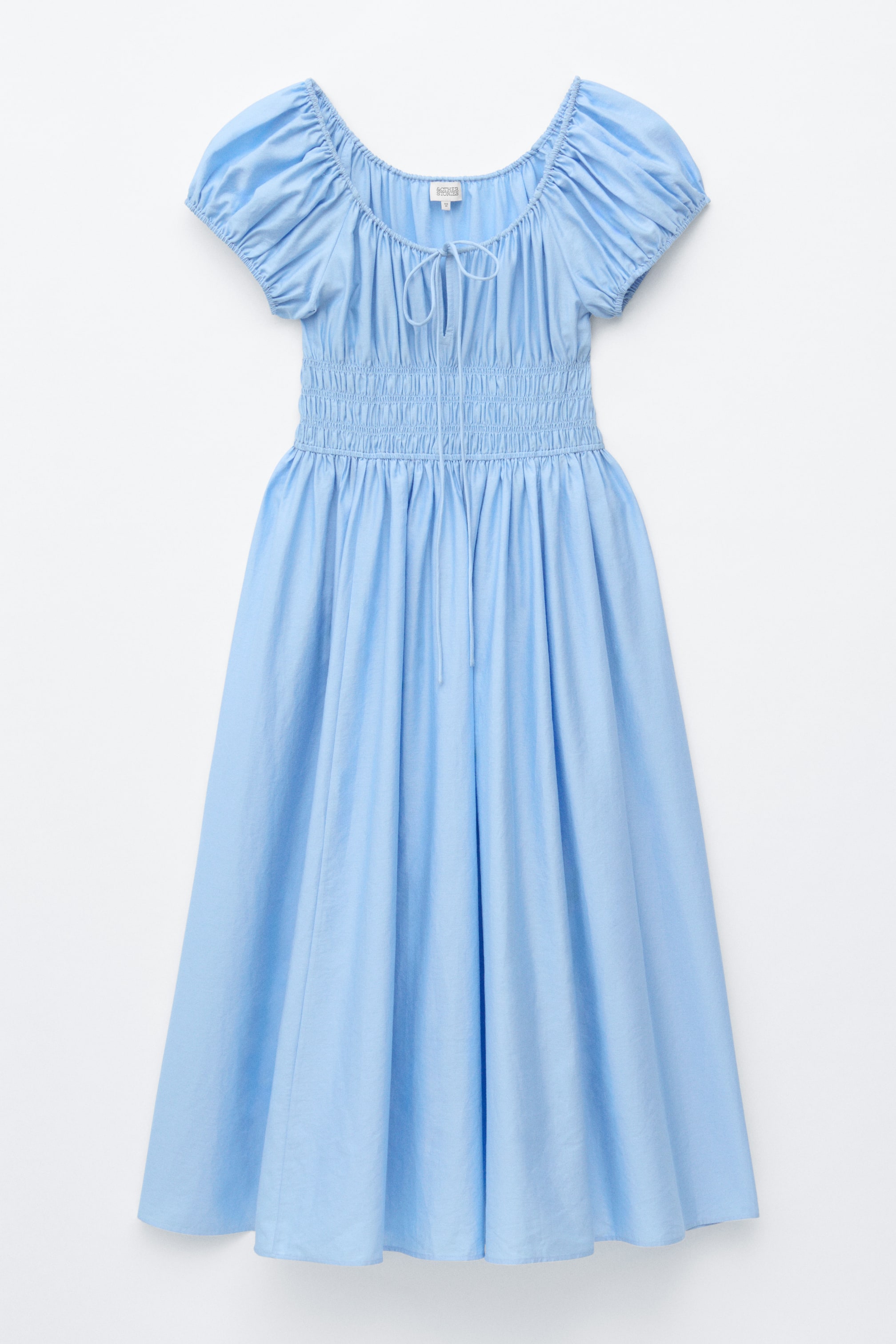 View larger image: A light blue midi dress is showcased from the front, featuring a gathered square neckline with a front tie, short puffed sleeves, and a shirred bodice that ends at a drawstring waist, transitioning into a full, flowing skirt.