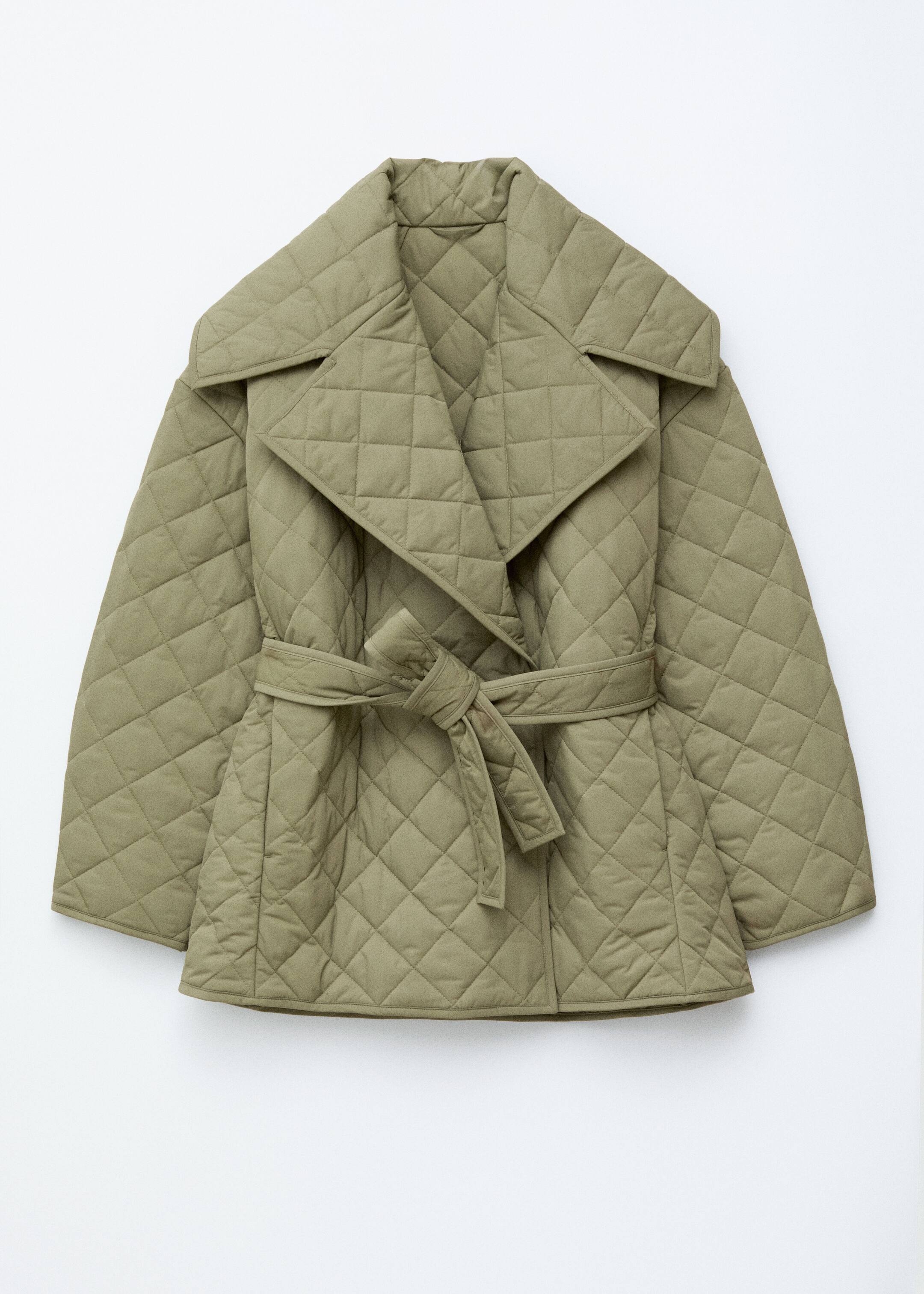 View larger image: An olive green quilted jacket is being presented from the FRONT, displaying a diamond pattern throughout its wide, slightly cropped silhouette. A wide open collar is framing the neckline, and a matching fabric tie belt is cinching the waist and is knotted at the front.