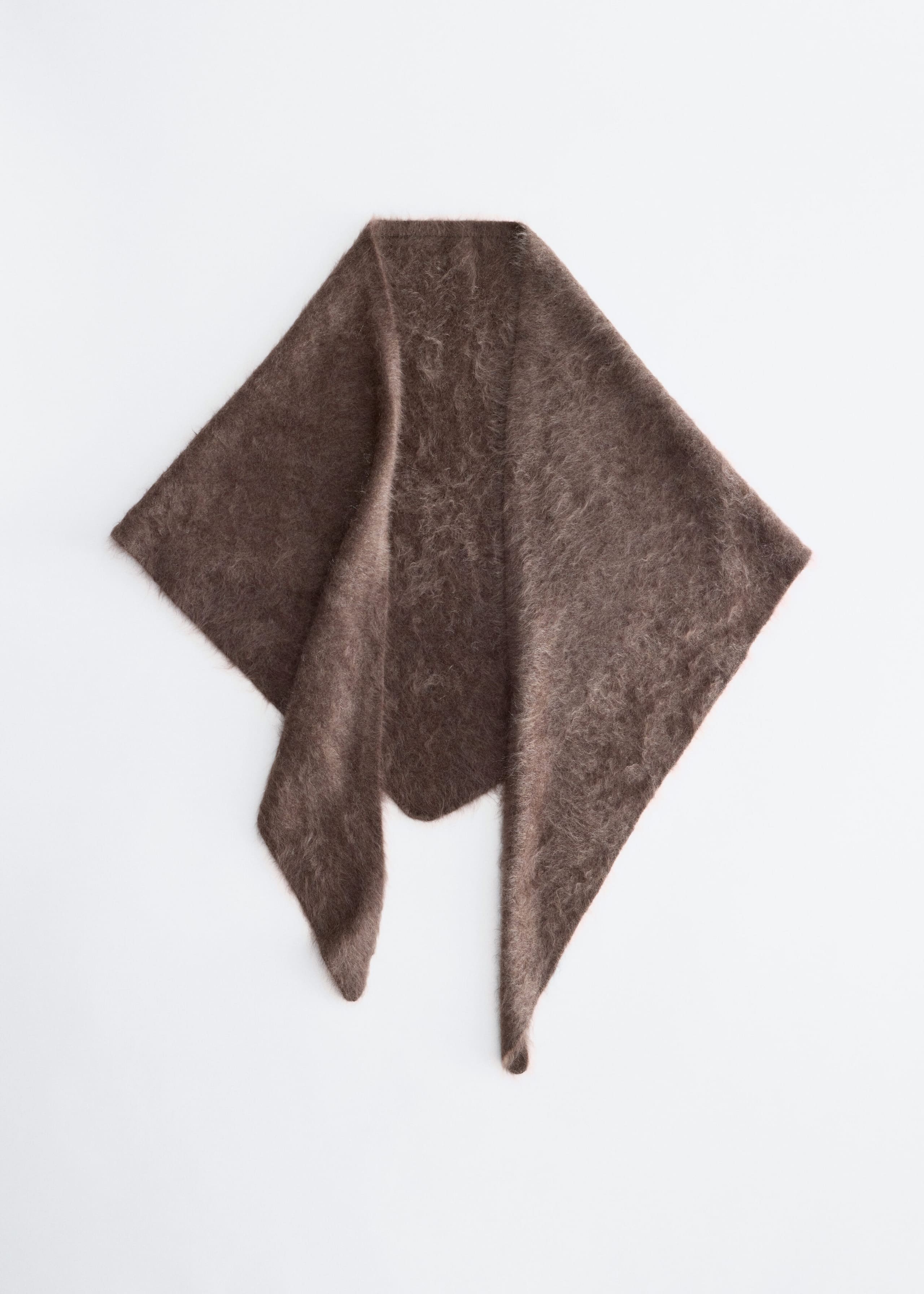 A brown, fuzzy knit triangular scarf lies flat in a front-facing view, showcasing its soft, brushed texture and pointed ends. The scarf is draped symmetrically to highlight its plush, mohair-like fabric and rich brown color.