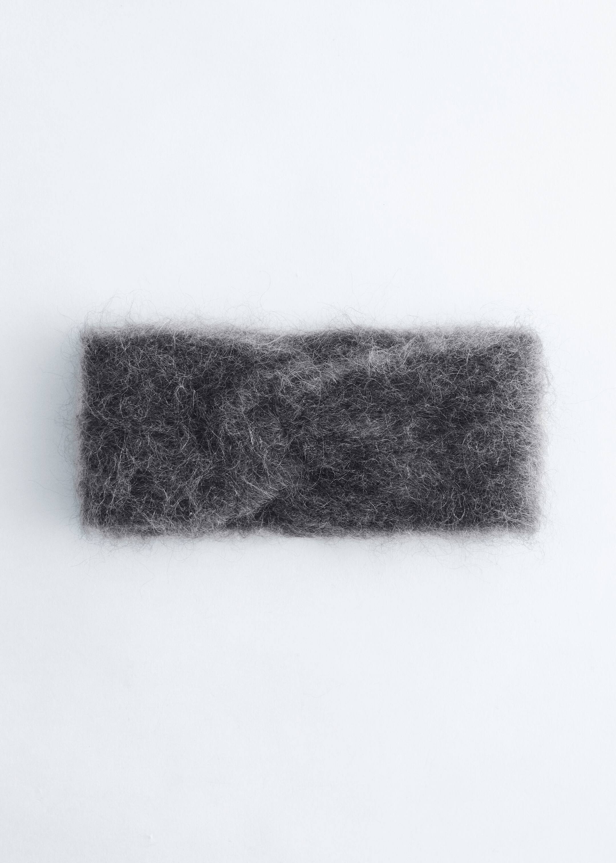 View larger image: The Mohair-Blend Twist-Front Headband is displaying a dark gray, fuzzy texture. It is featuring a prominent twist at its front center, lying flat.