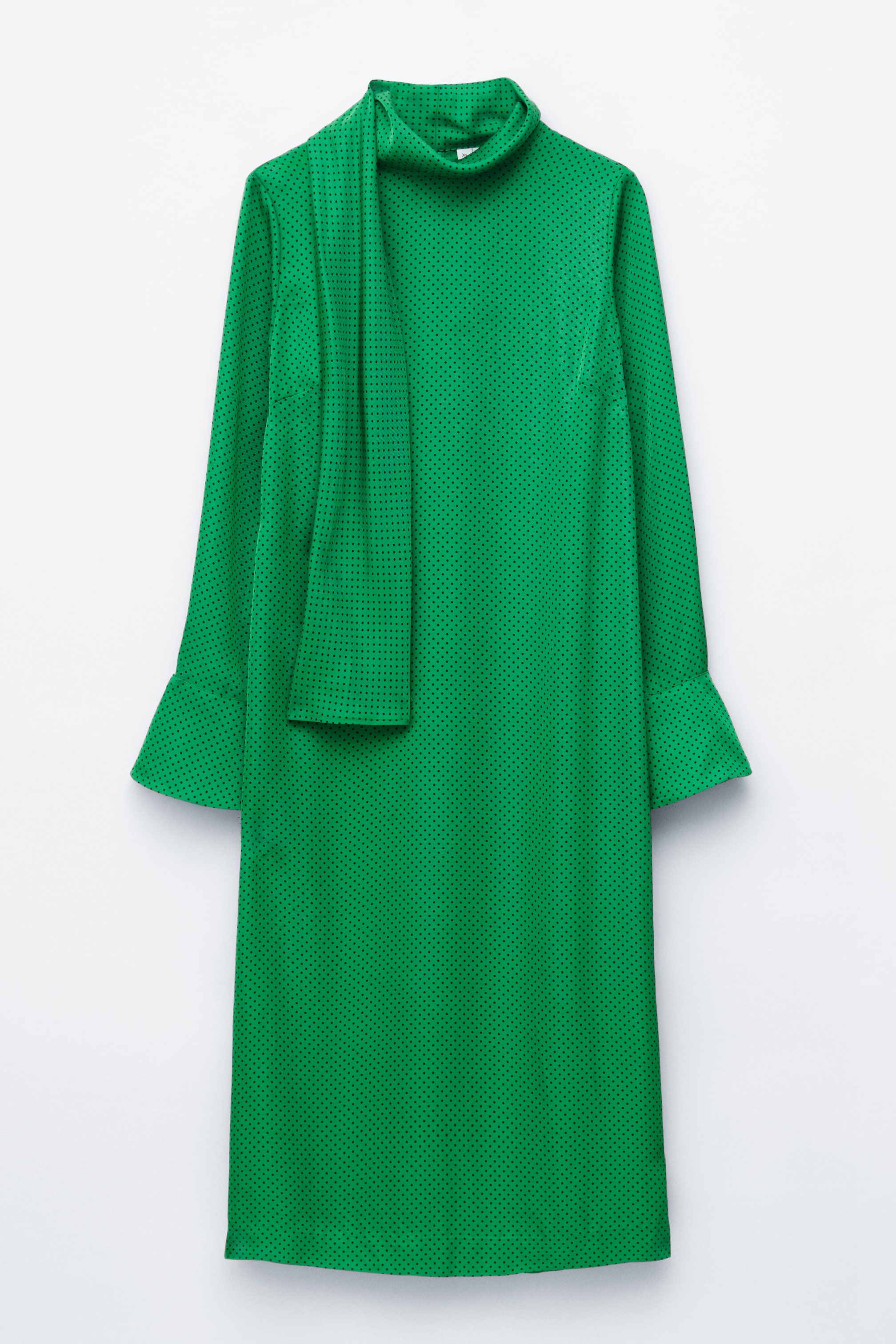 View larger image: A green dress adorned with small black polka dots is facing FRONT, showcasing a high neck with an attached scarf detail elegantly draping down the left side, and long sleeves with wide, flared cuffs.
