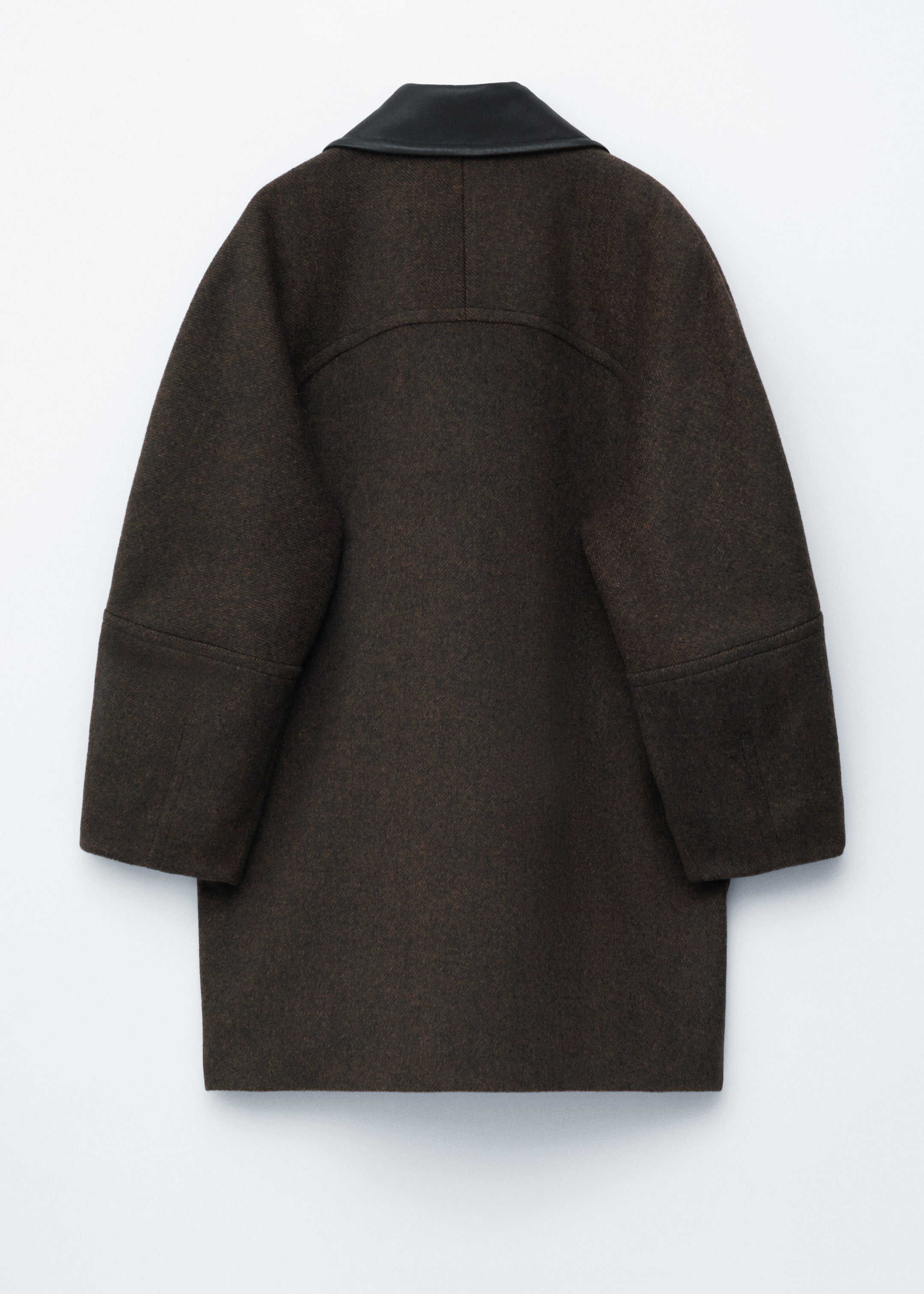 View larger image: A dark brown textured coat is seen from the back. It is featuring a black leather collar, a curved back yoke, and wide, slightly cropped sleeves with a horizontal seam above the cuffs.