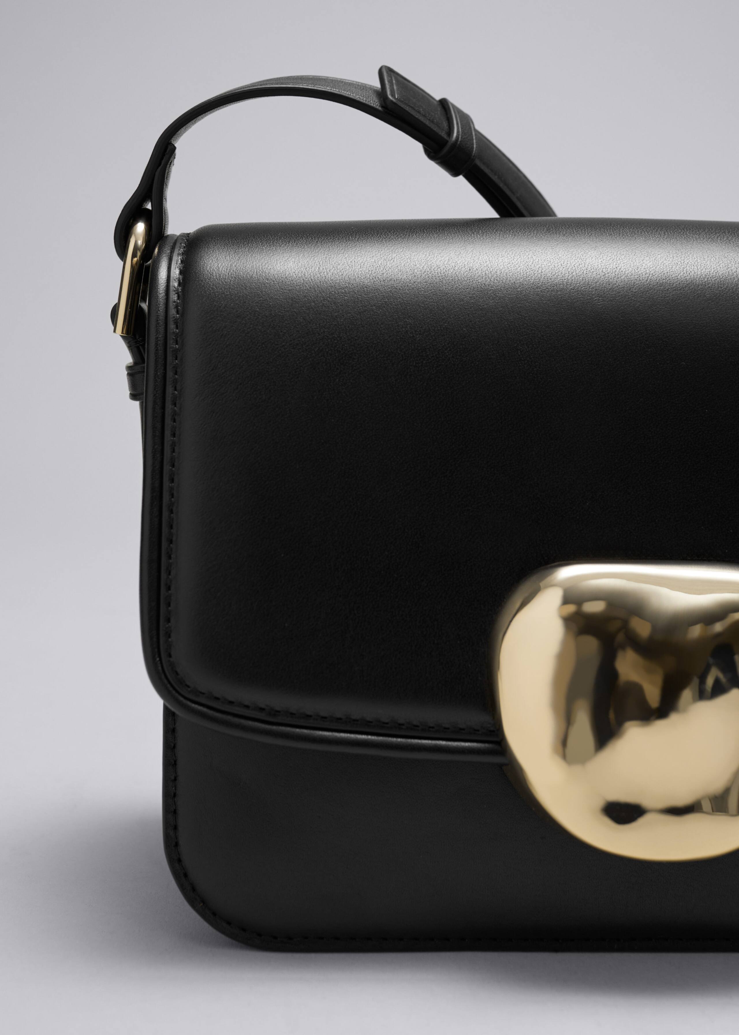 Borsa in pelle con fibbia scultorea - {{variantName}} - Descrizione dettagliata