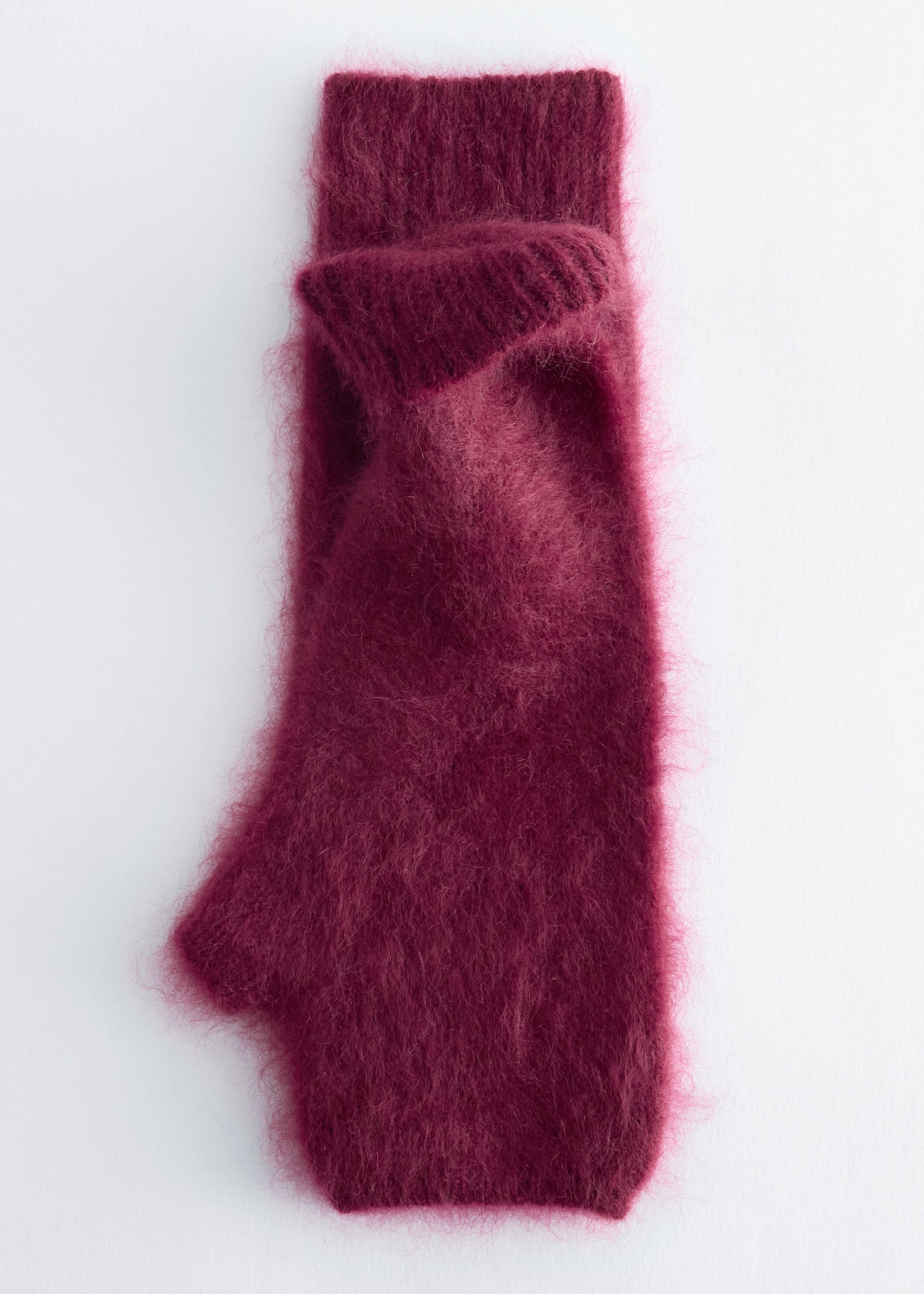 A fingerless glove in a deep burgundy hue lies flat, showcasing its highly textured, fuzzy brushed finish from the front. The glove features a distinct thumb opening on the side and a folded-over ribbed cuff.