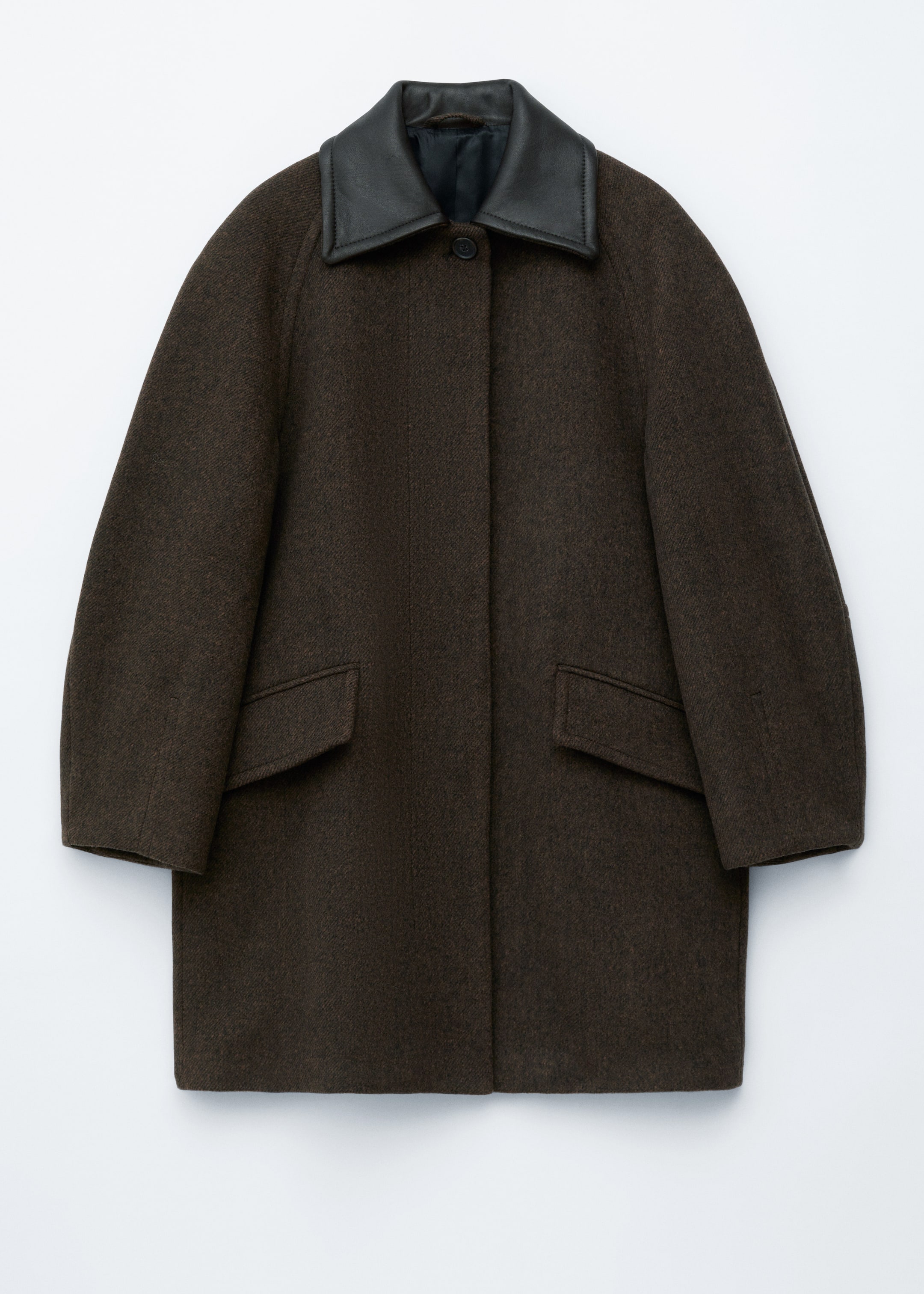 View larger image: A textured dark brown coat is displayed front-facing, featuring a contrasting black leather collar and raglan sleeves. A hidden button placket is running down the front with one visible button, and two flap pockets are positioned on the lower front.
