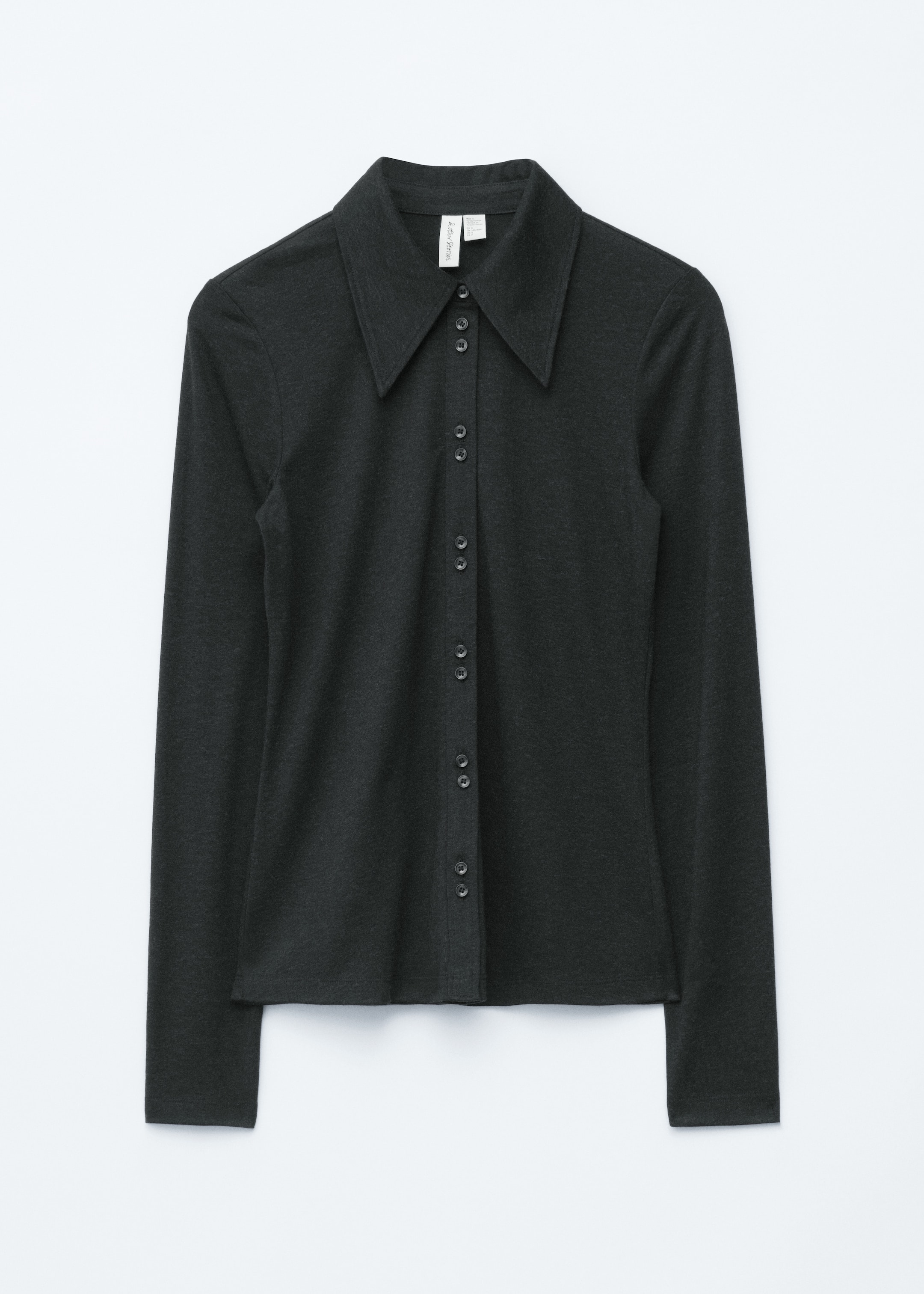 View larger image: A dark grey long-sleeved shirt is displayed from the front. It is featuring a wide, pointed collar and a full button-front placket with small, dark buttons. The long sleeves are ending in simple cuffs.