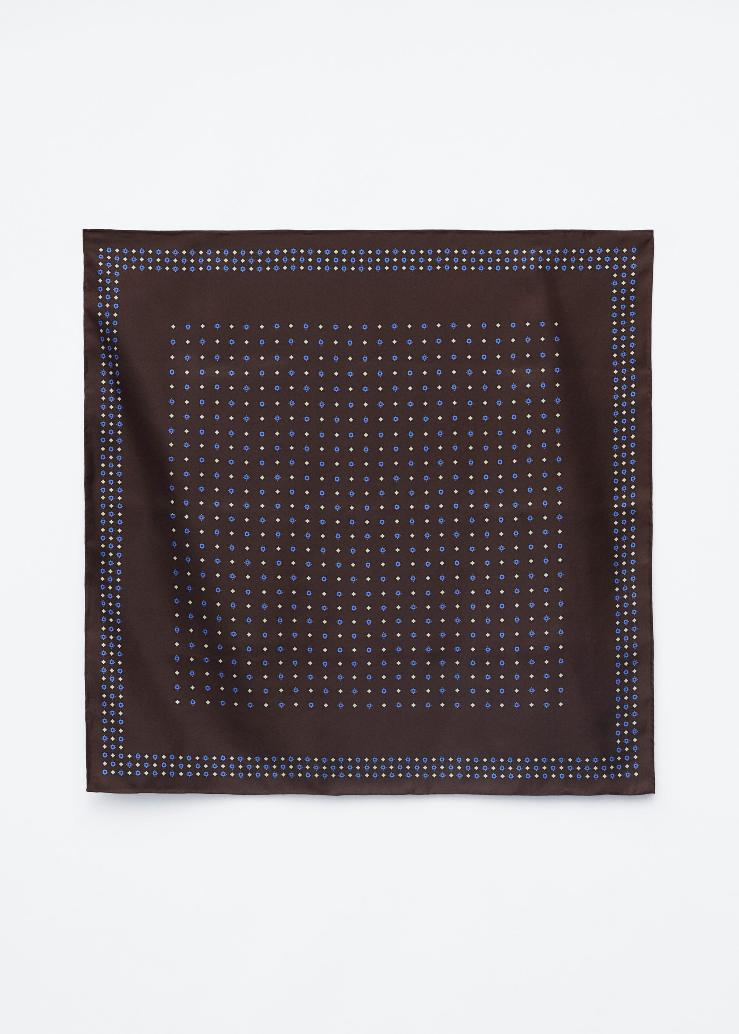 A square silk scarf is laid flat, facing forward, featuring a dark brown base decorated with an all-over repeating pattern of tiny blue and cream geometric shapes. A matching double-row geometric border frames the design, finished with a solid brown hemmed edge.