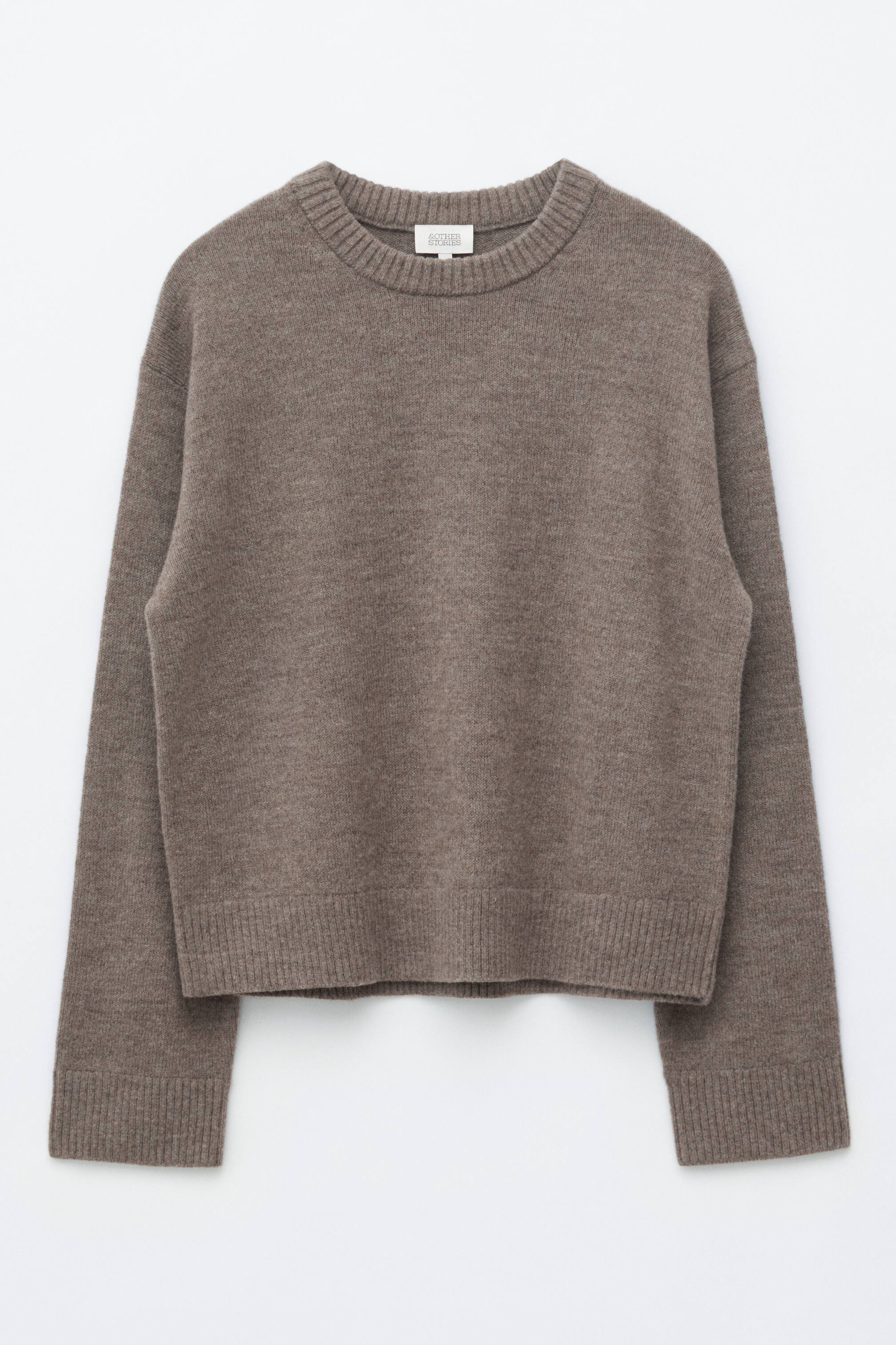 View larger image: A brown knitted jumper is showcased from the front. It features a crew neck, long sleeves, a boxy fit, and ribbed trims on the collar, cuffs, and hem.