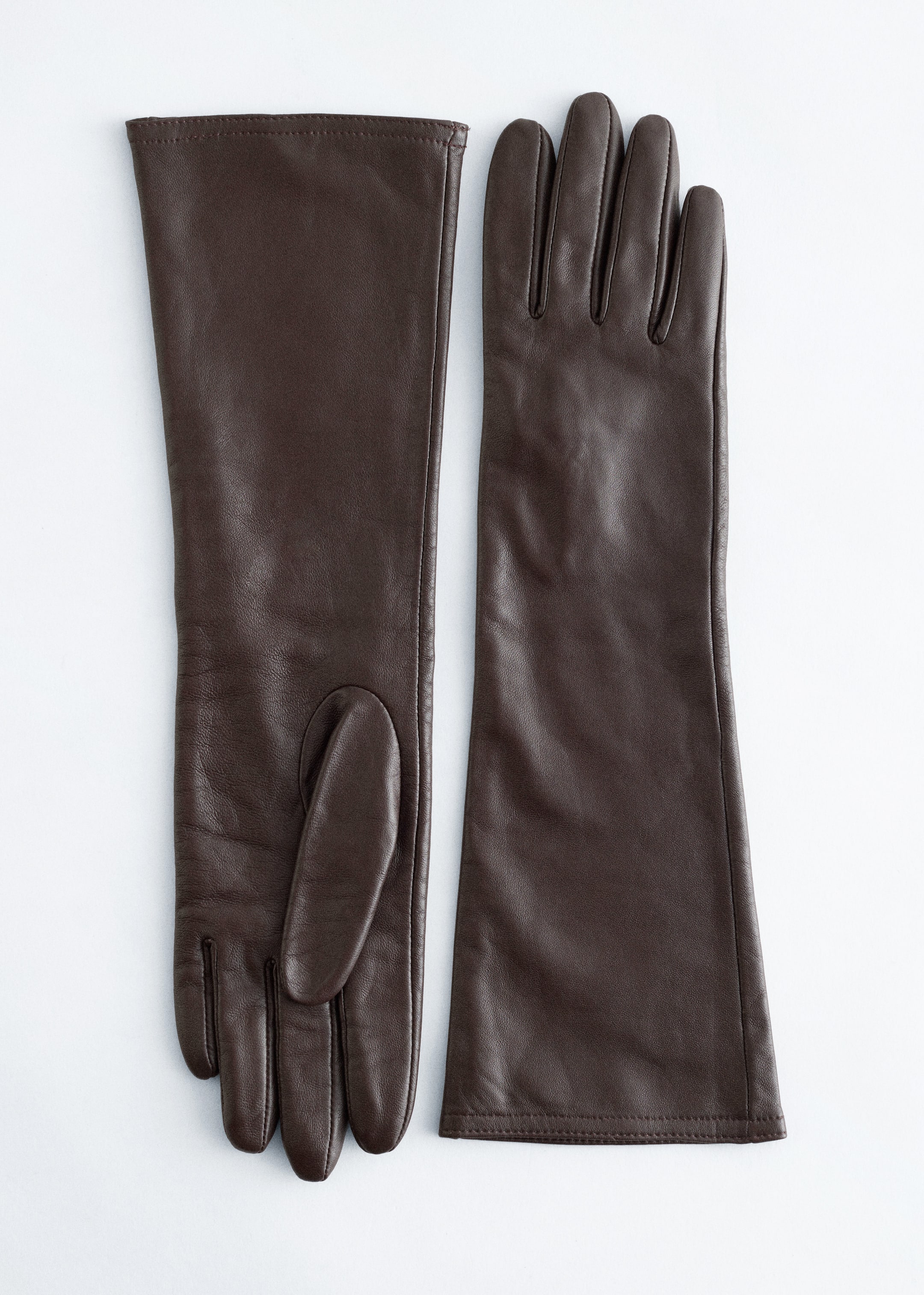 View larger image: Two dark brown leather gloves are lying flat, side-by-side, with the left glove presenting its palm side, showing a distinct thumb piece, and the right glove presenting its back side, featuring defined finger divisions. Both gloves are extending to a long, nearly elbow length.