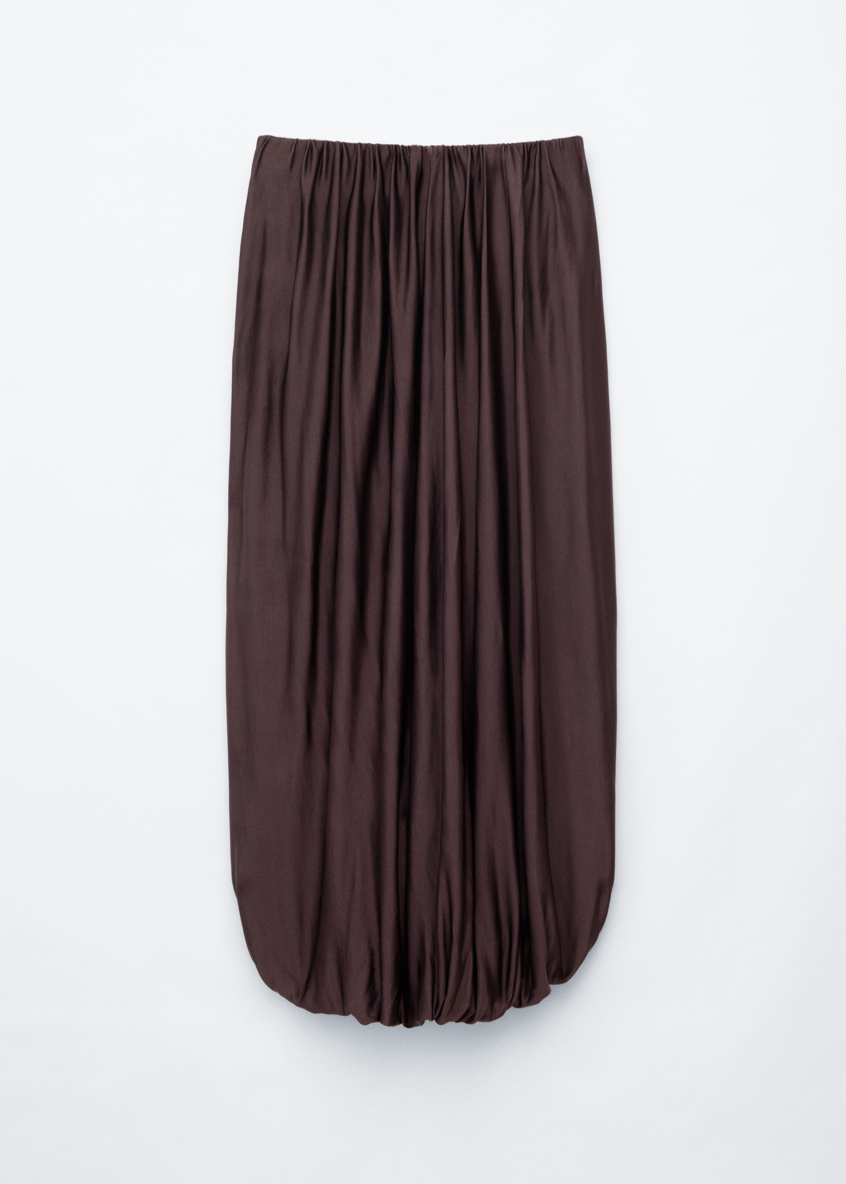 The model is wearing a brown flowing skirt with a gathered elasticated waistband, styled with a cream ribbed knit top.