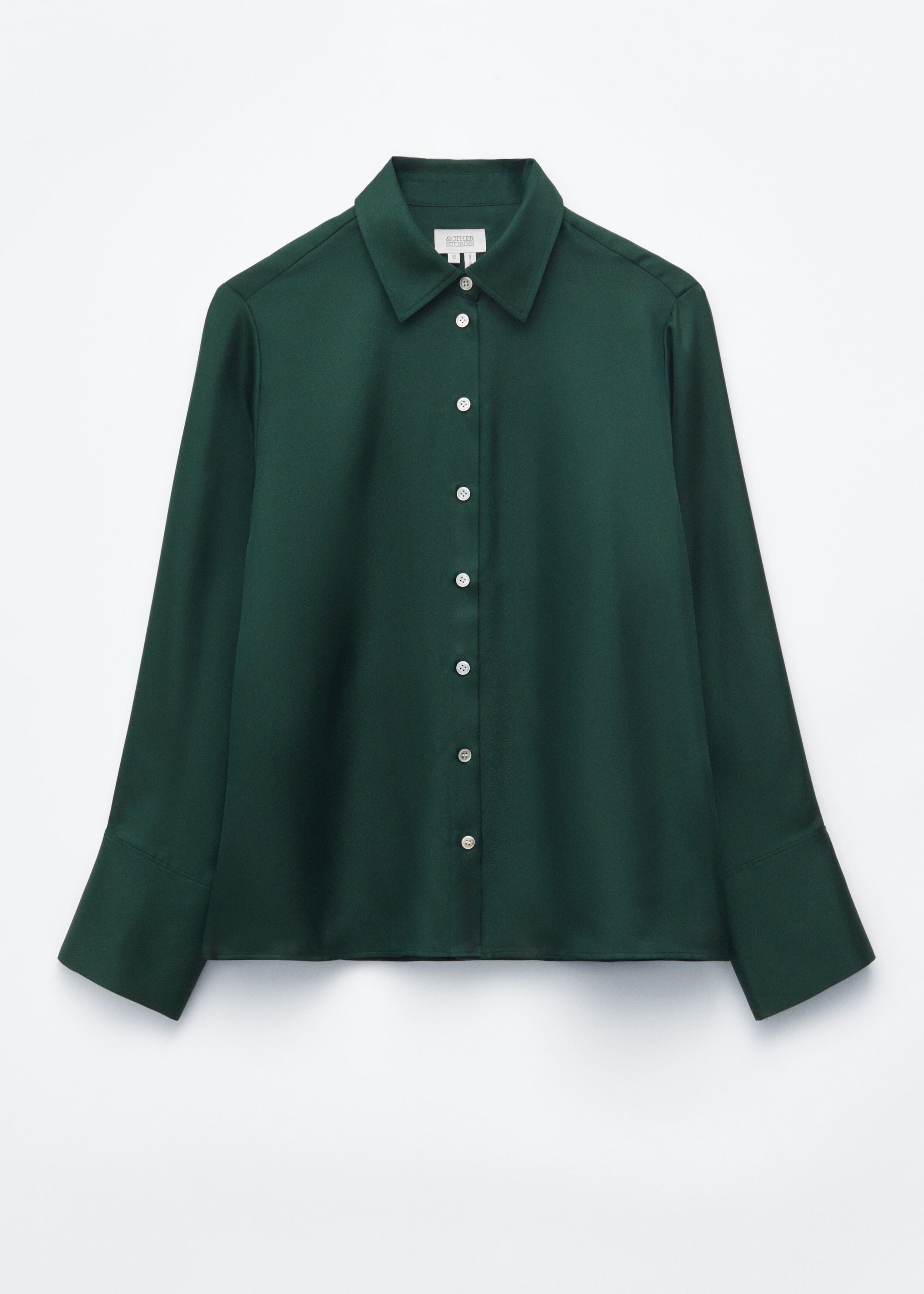 A dark green silk shirt is shown from the front, featuring a relaxed silhouette with a lustrous finish. The shirt has a classic collar, a button-down front with light-colored buttons, and long sleeves with wide, structured cuffs.