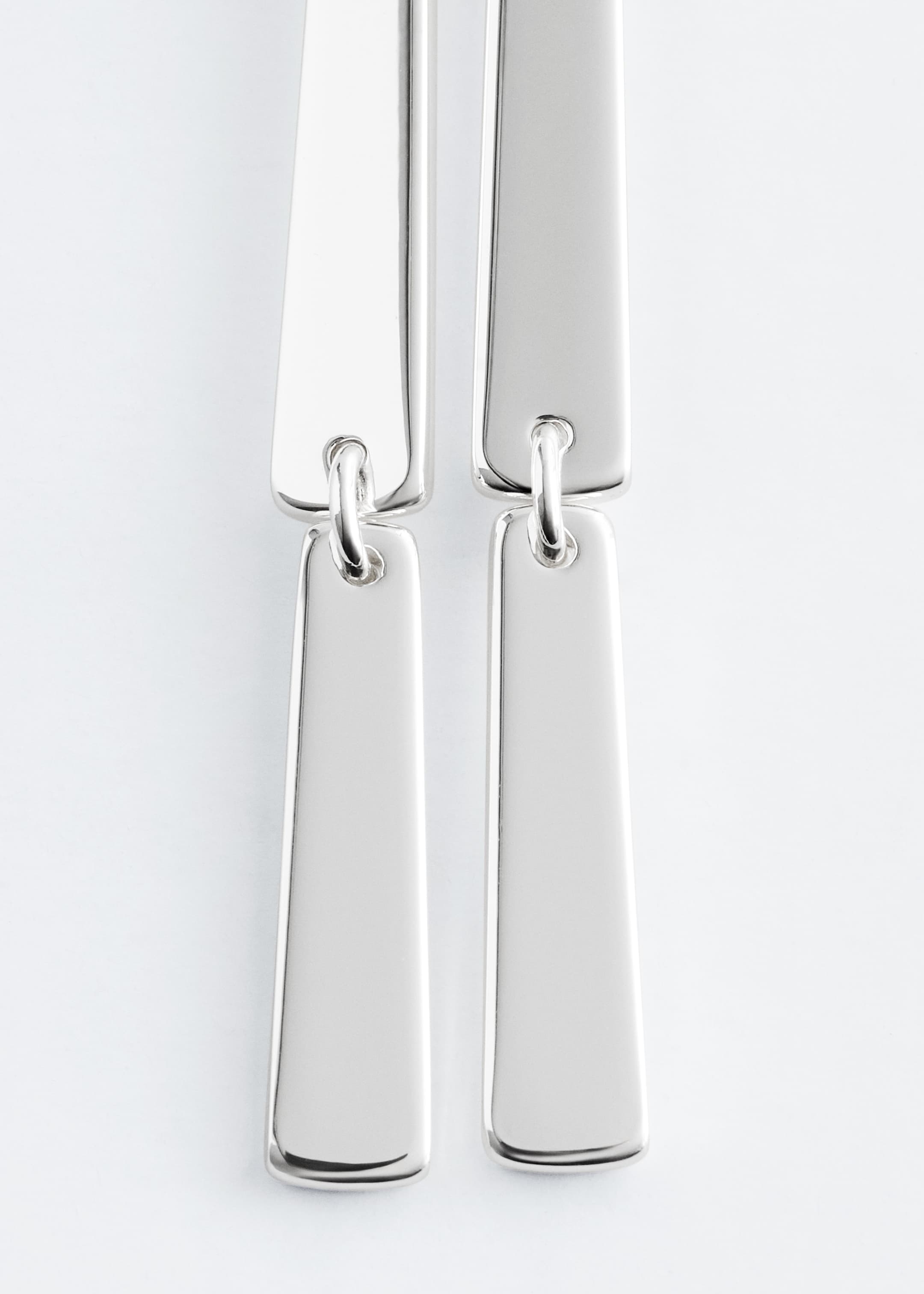 View larger image: Two polished silver-toned pendant earrings are featuring interlinked rectangular plates, with the bottom-most visible plates displaying softly rounded corners.
