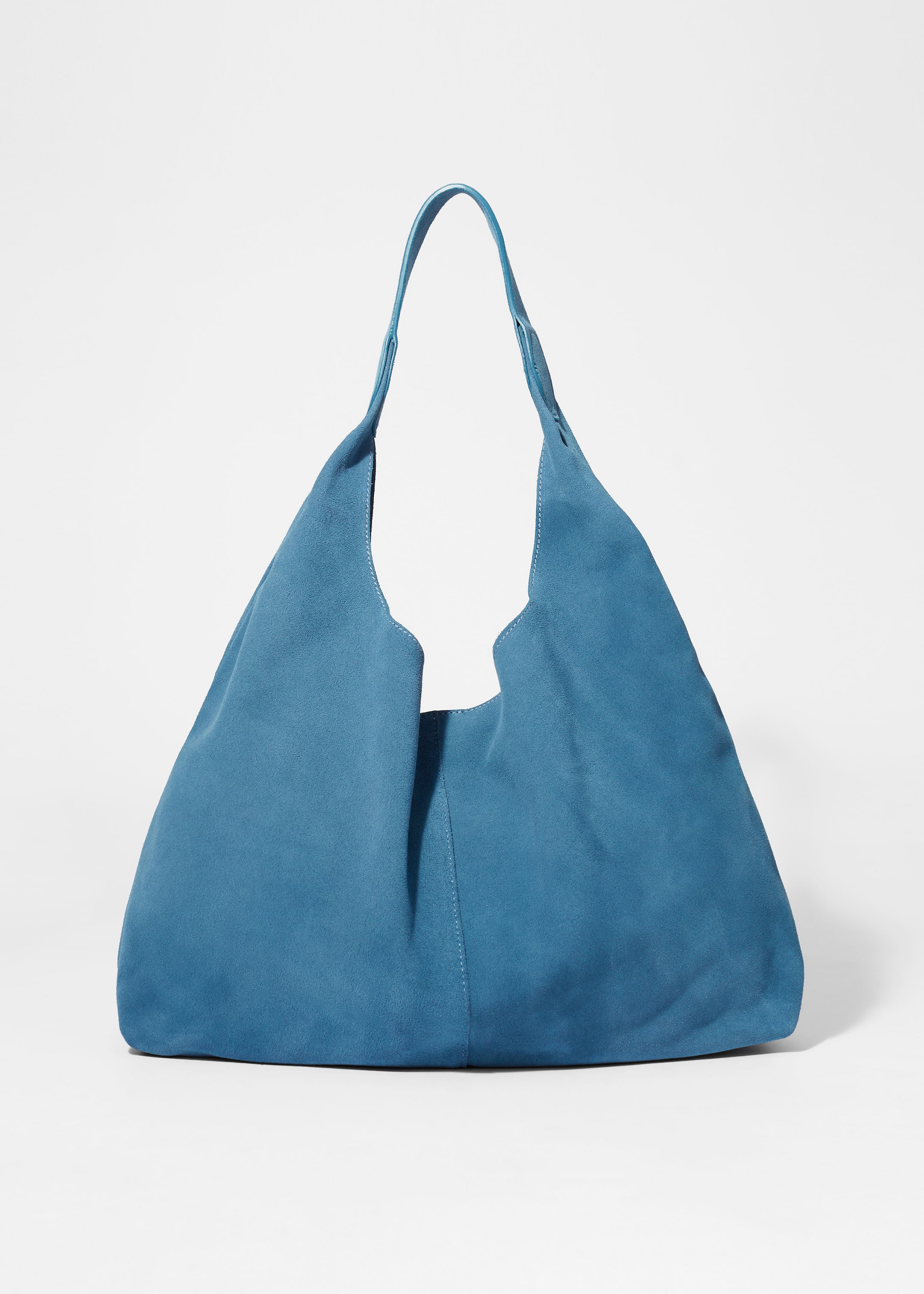 Vis større bilde: En blå totebag, laget av glatt semsket skinn med en matt finish, viser frem forsiden. Den har en dekorativ søm som løper nedover midten og et enkelt håndtak festet til en buet åpning.