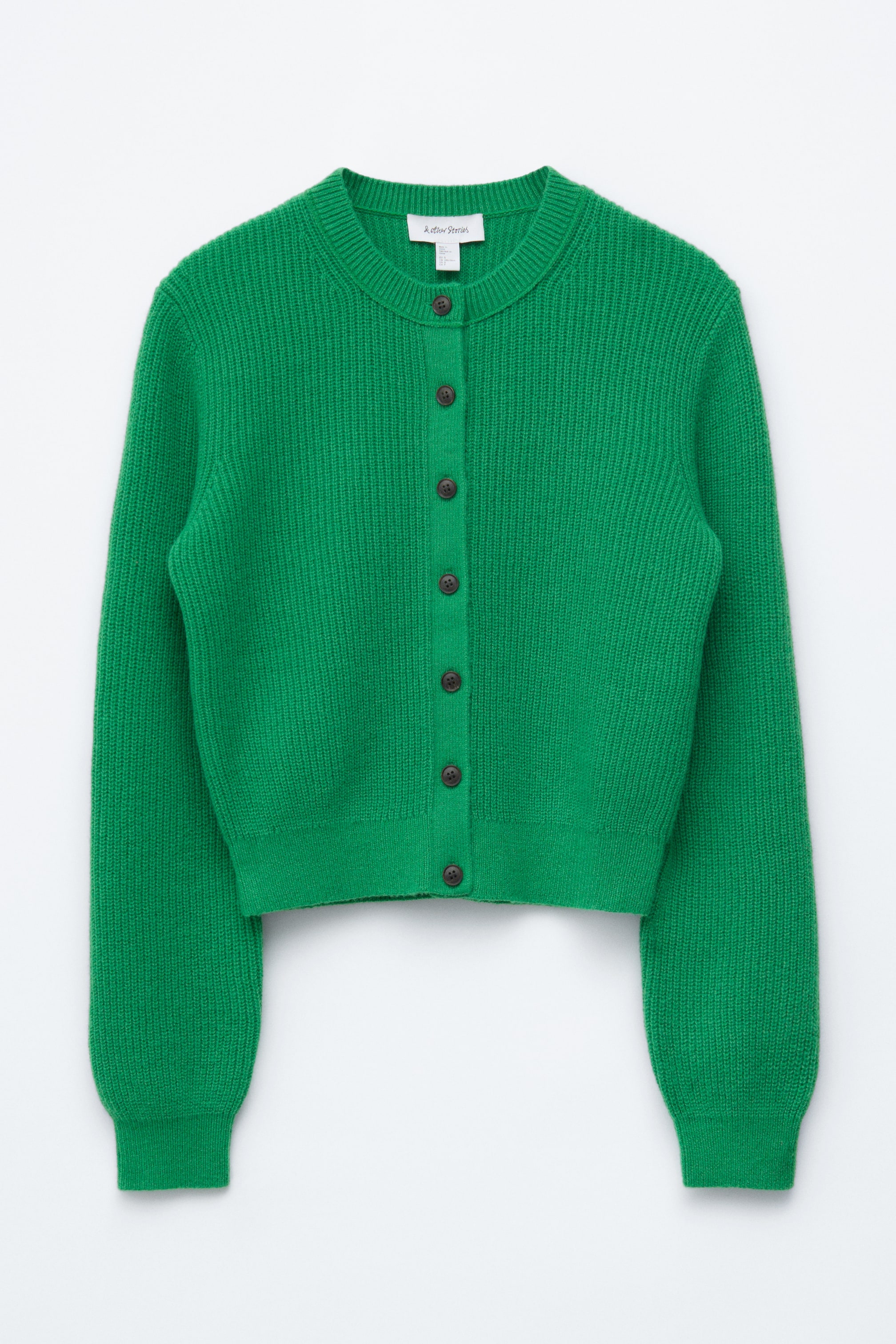 הצגת תמונה גדולה יותר: קרדיגן ירוק בהיר פונה קדימה, מציג מרקם סריג מצולע, צווארון עגול וסגירה מלאה עם כפתורים חומים כהים, משלים את המראה עם שרוולים ארוכים עם חפתים מצולעים ושוליים מצולעים.