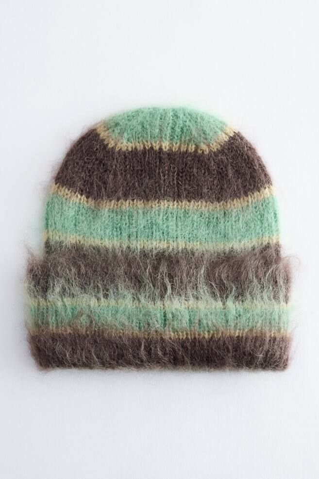 A knitted beanie is shown from the front, featuring horizontal stripes of dark brown, mint green and thin beige. The beanie has a single-fold cuff at the bottom, highlighting its highly textured, fuzzy mohair finish. - 1