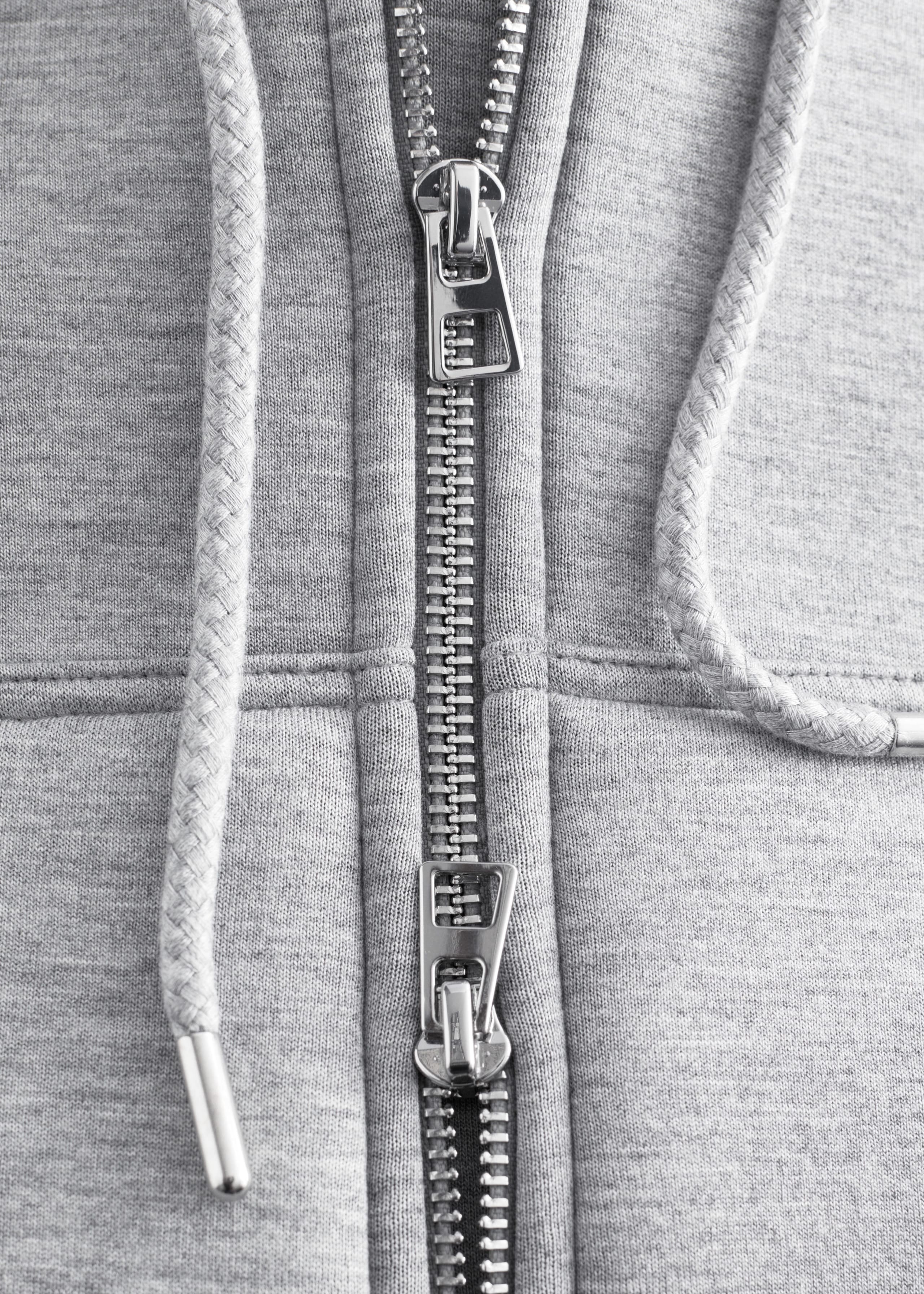 Image of Felpa cropped in scuba con cappuccio e zip