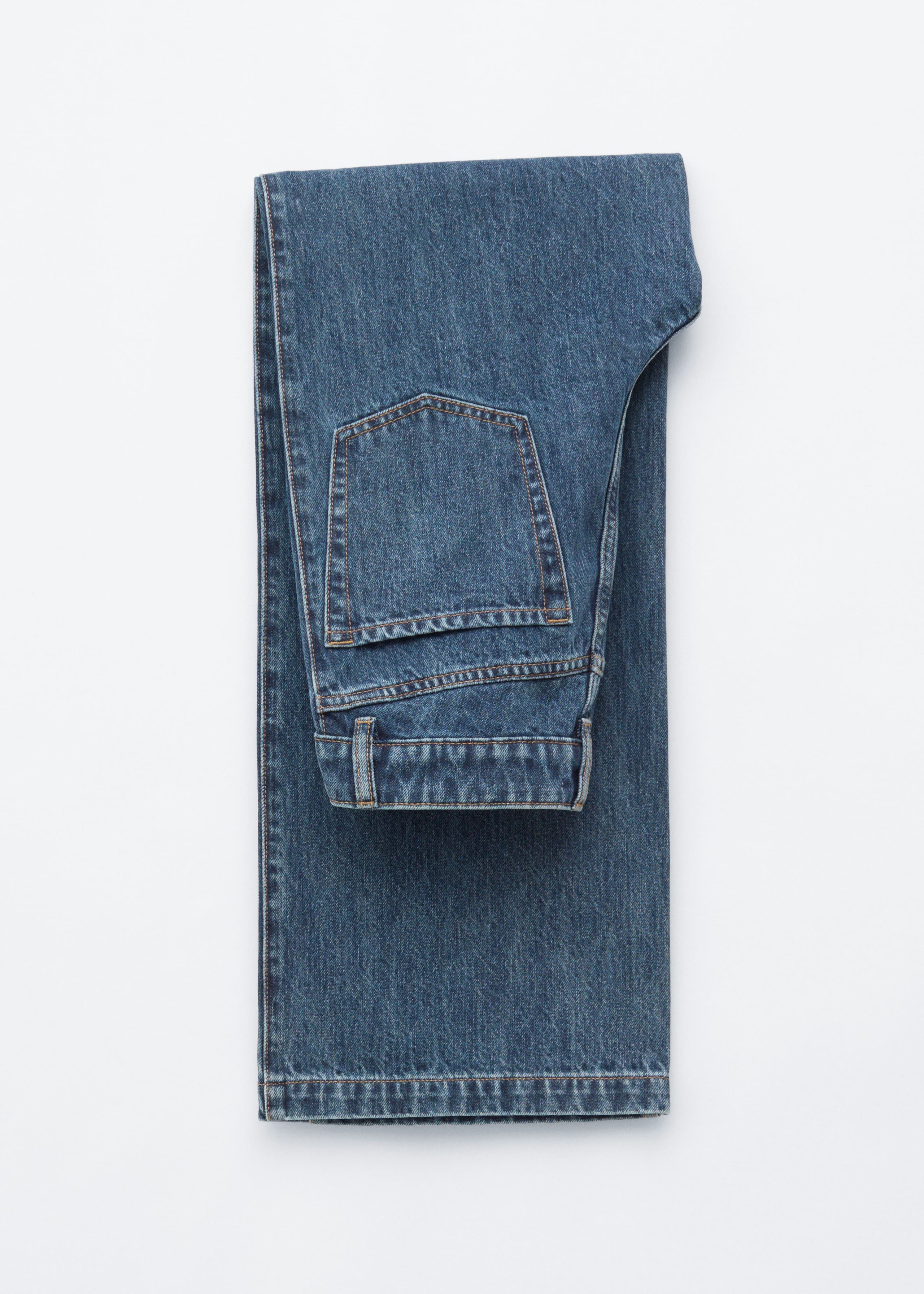 Blue denim jeans are folded flat, showing the back pocket, waistband with belt loops, and contrast stitching.