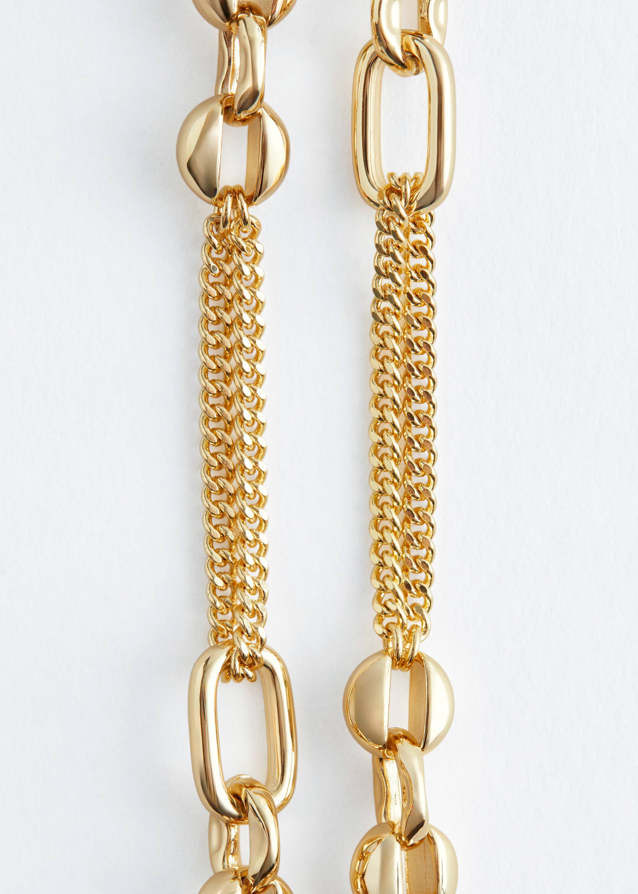 View larger image: A gold-toned necklace is presented front-facing, featuring two visible sections of its design. It is composed of alternating large, polished round links and elongated, rectangular-oval links. Smaller, double-strand curb chains are connecting these larger links.