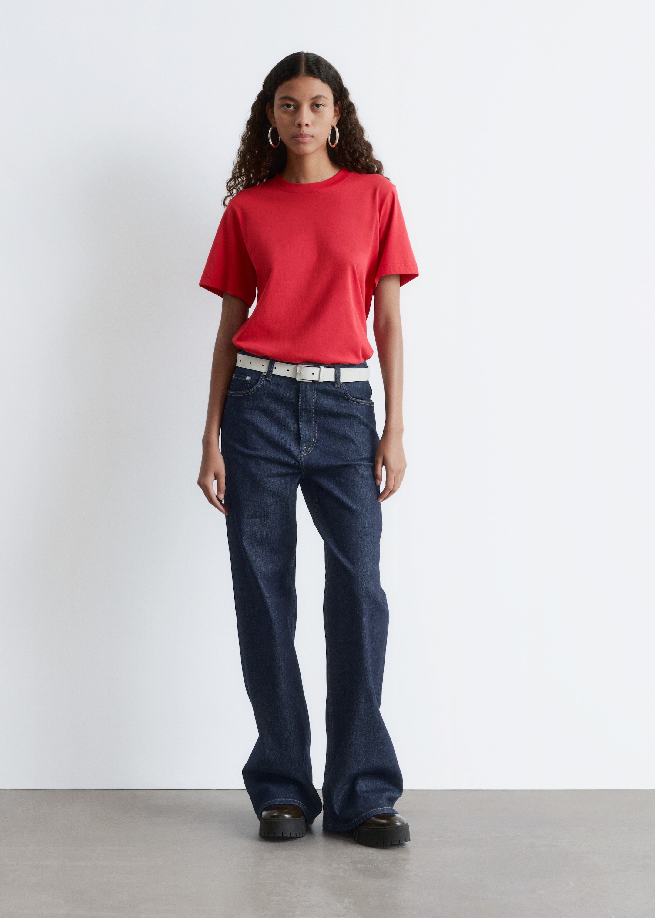 View larger image: A red crew-neck t-shirt with short sleeves is being presented front-facing. It is appearing in a classic, relaxed fit and is tucked into dark wash jeans.