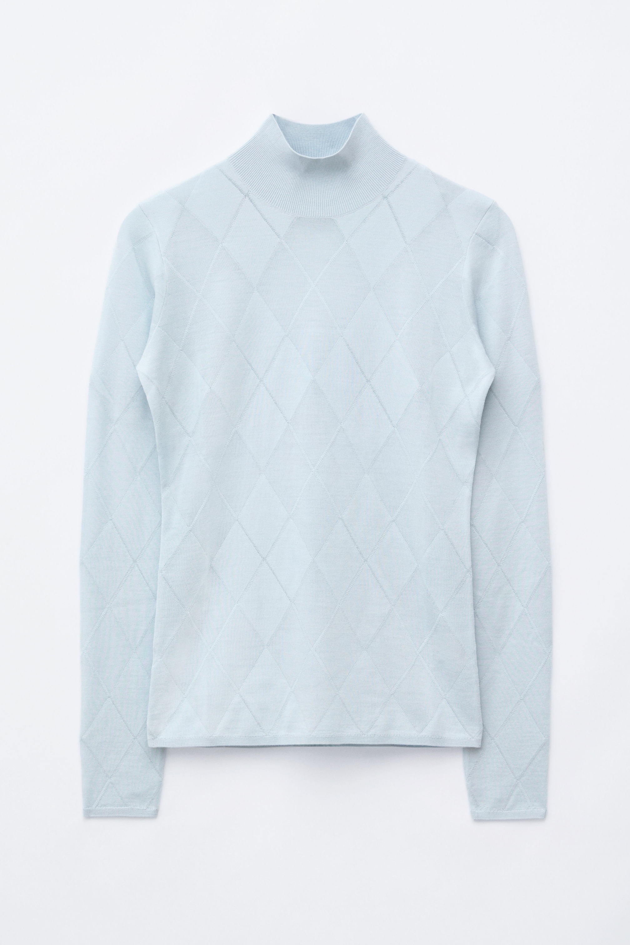View larger image: A light blue wool knit top is displayed front-facing, laid flat. It features a ribbed mock neck, ribbed cuffs, and a ribbed hem, with a diamond pattern visible across the entire garment.
