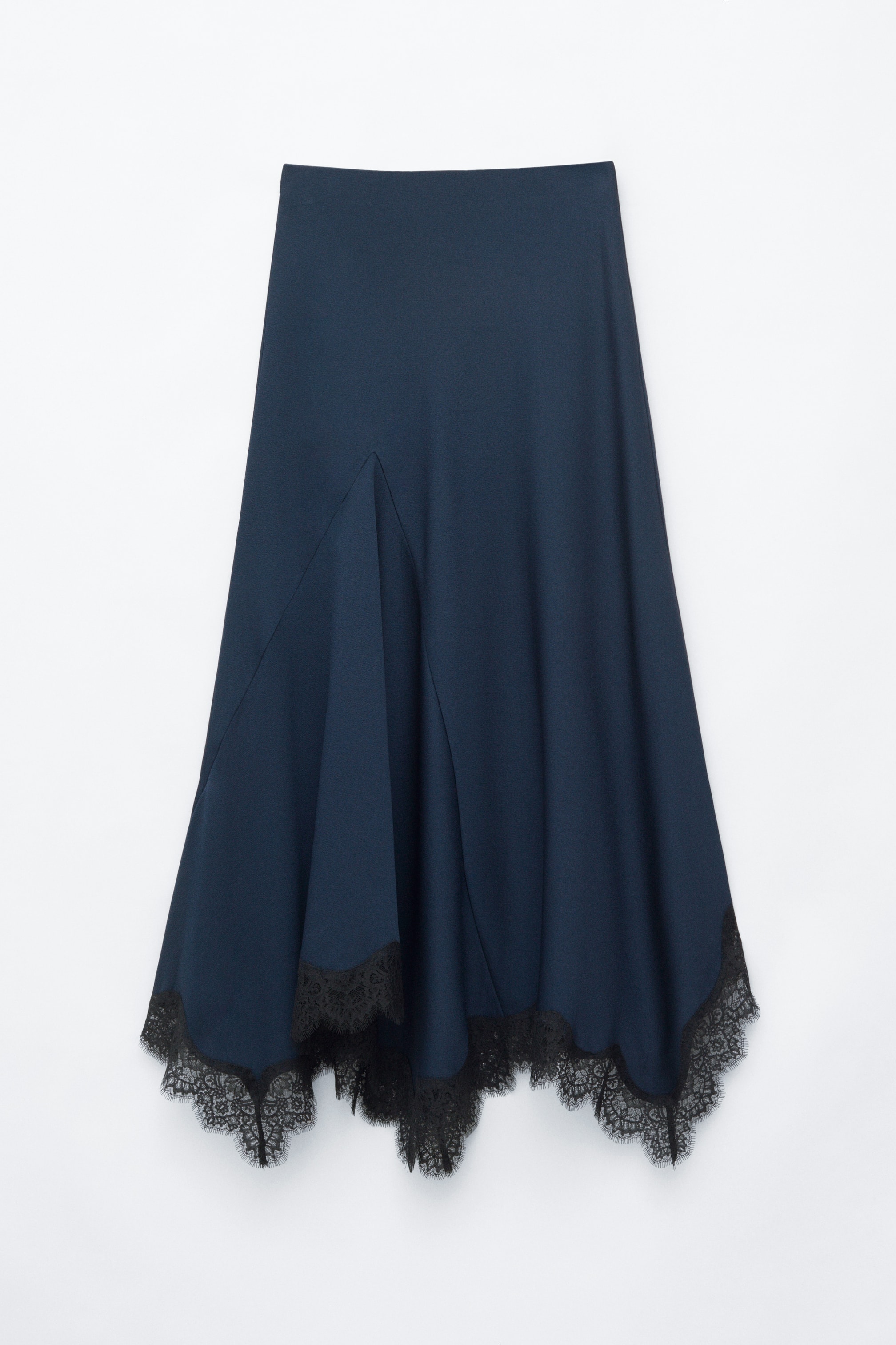 View larger image: A dark blue flared skirt is shown from the front, featuring a flowing silhouette and an asymmetrical hemline detailed with black lace.