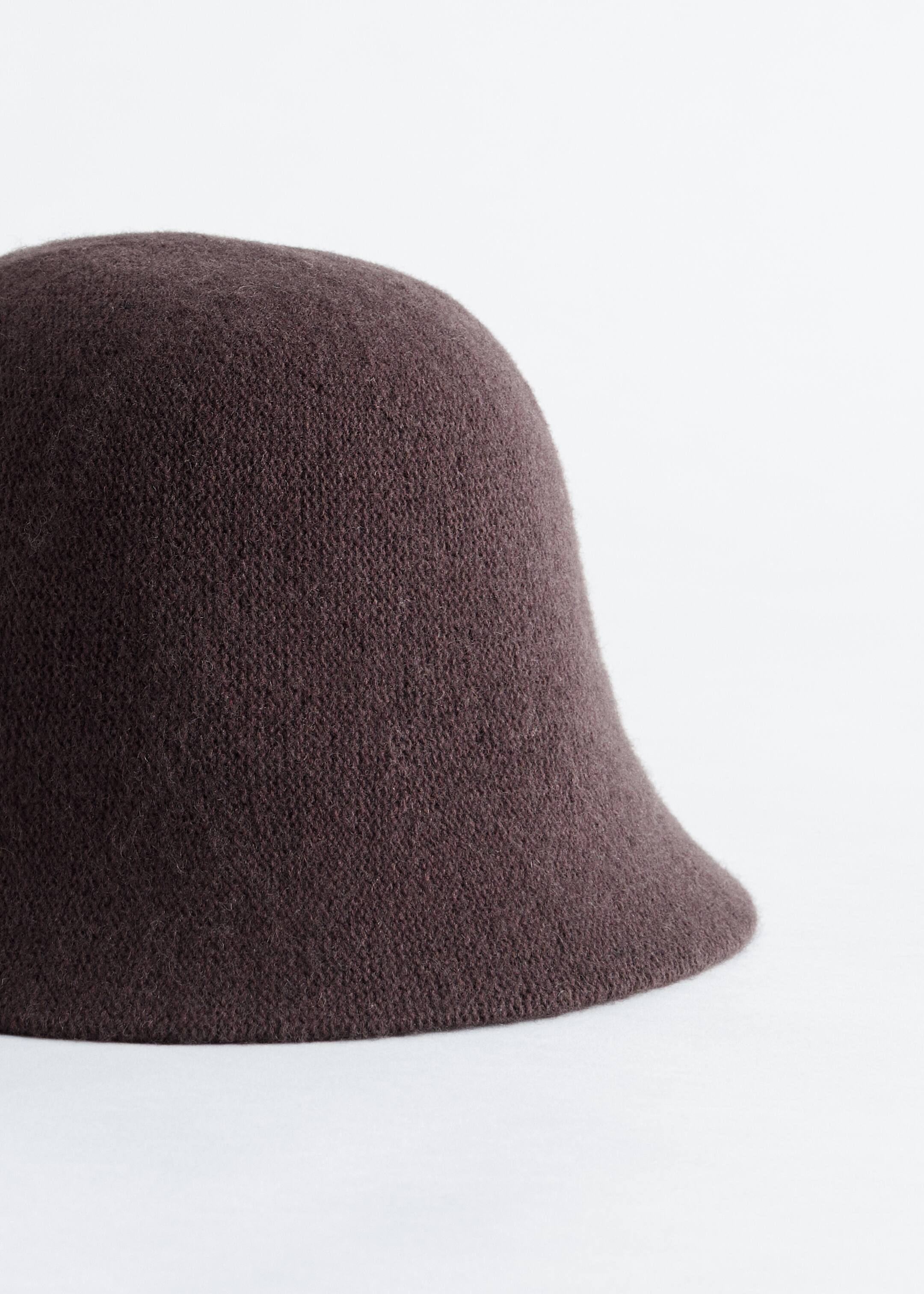 View larger image: A dark brown knitted moulded bucket hat is featuring a rounded crown and a slanted brim.