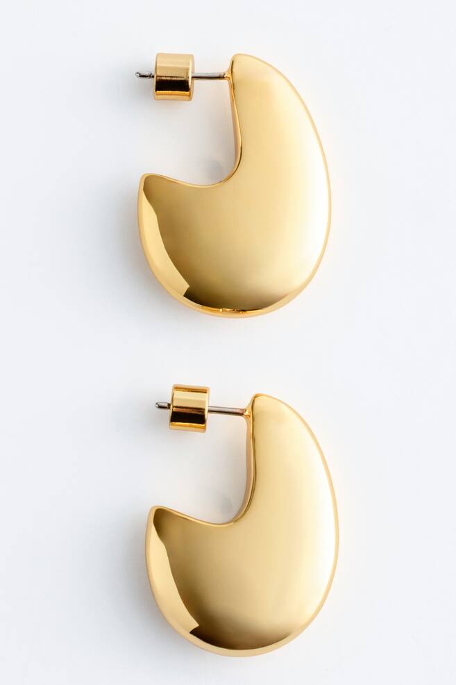 Two chunky earrings featuring a sculpted droplet form and a polished brass finish, with their front and side profiles visible. Each earring displays a post and push-back fastening, measuring 3.8cm in height and 0.88cm in width. - 1