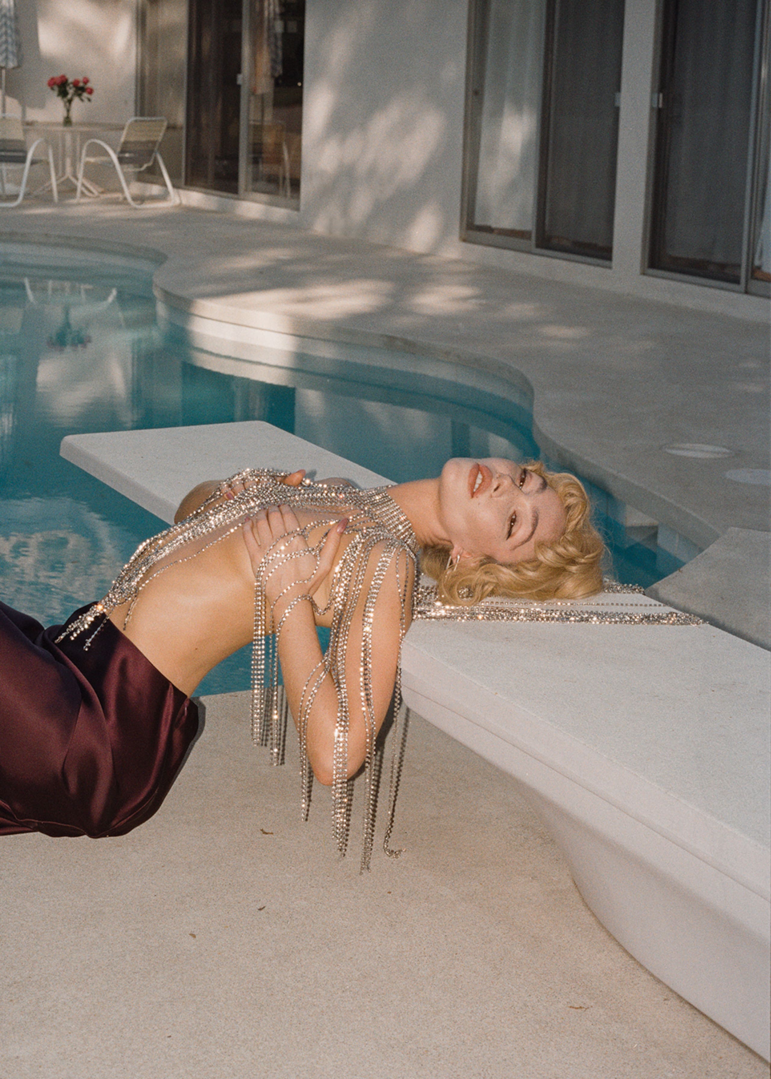 Woman in rhinestone jewellery by the pool